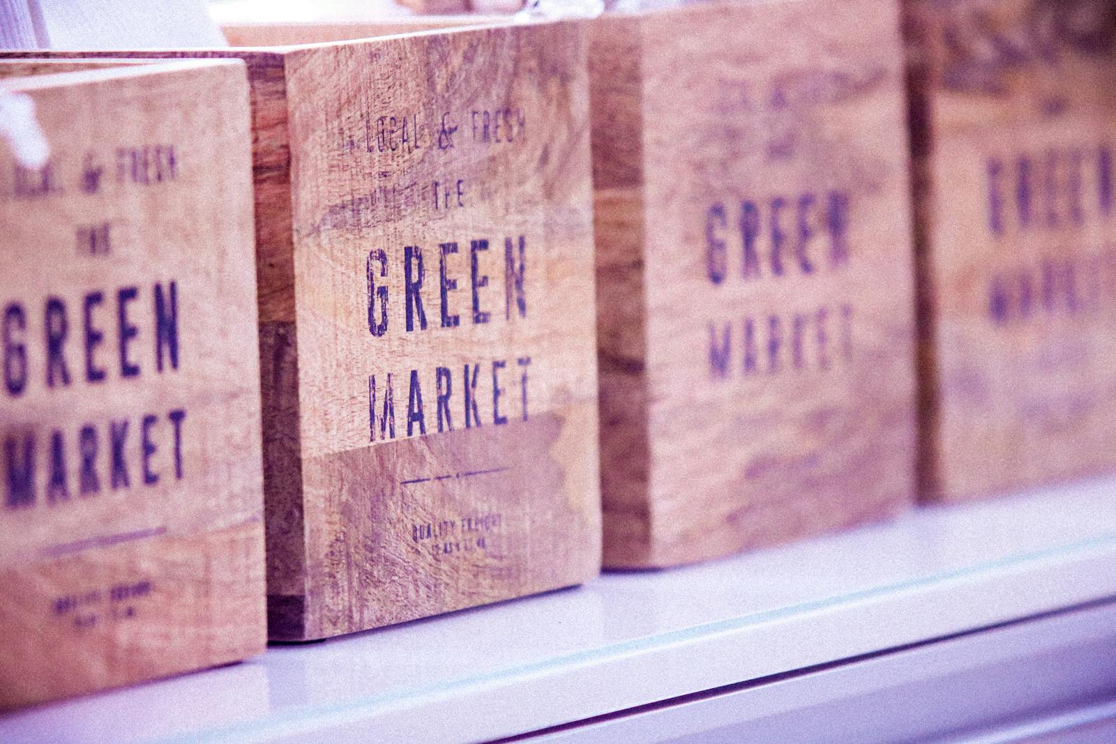 Close-up of vintage wooden boxes with green market text, ideal for commerce themes.